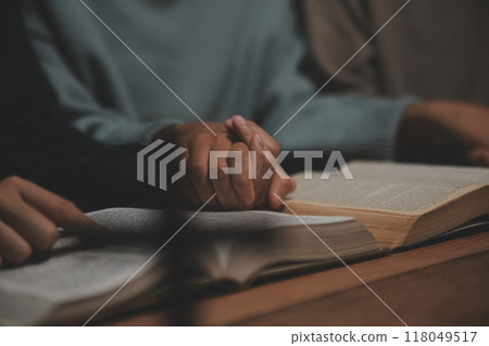 Christian group are praying to god with the bible and sharing the gospel. Concept of faith for god. Christian group are praying to god with the bible and sharing the gospel. Concept of faith for god. 118049517