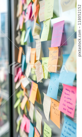 A wall covered in colorful sticky notes with various words 118052152