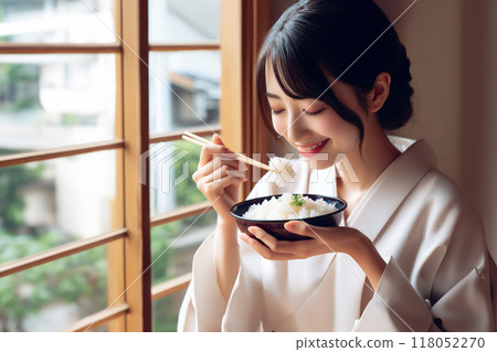 A woman eating white rice 118052270
