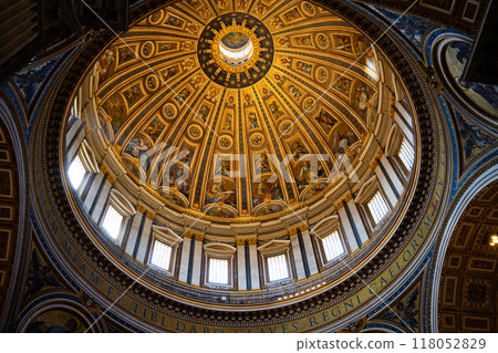The breathtaking dome of Saint Peter Basilica features intricate frescoes and gilded details. Natural light filters through the windows, illuminating the stunning artwork high above. The breathtaking dome of Saint Peter Basilica features intricate frescoes and gilded details. Natural light filters through the windows, illuminating the stunning artwork high above. 118052829