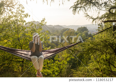 Relaxing Woman in Hammock Amidst Nature Relaxing Woman in Hammock Amidst Nature 118053217