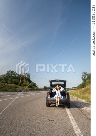 Woman Enjoying a Sunny Day by Her Car Woman Enjoying a Sunny Day by Her Car 118053232