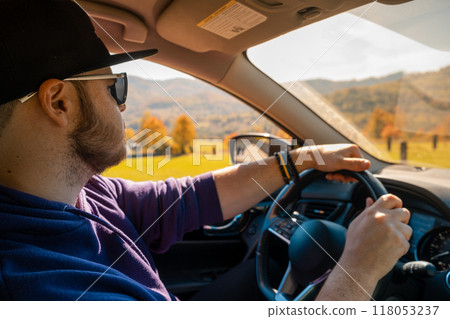 Man Driving Through Autumn Landscape Man Driving Through Autumn Landscape 118053237