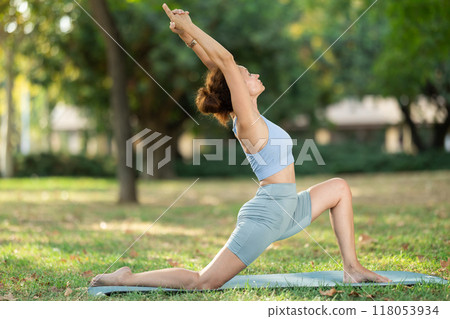 Adult woman doing stretching in park 118053934