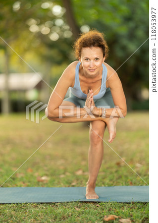 Adult woman doing yoga in park 118053977