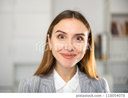 Portrait of female manager with different emotions on her face in modern office Portrait of female manager with different emotions on her face in modern office 118054078