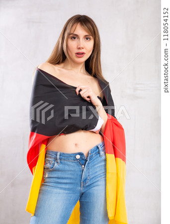 Young pretty woman proudly displaying flag of germany 118054152