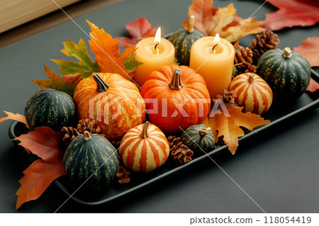 Autumn flat lay featuring pumpkins, candles, and leaves background. Concept of fall, harvest, and Halloween decoration 118054419