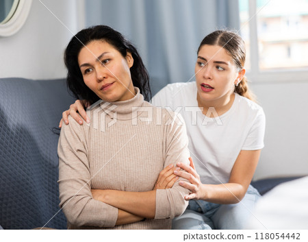 Young woman comforting her depressed female friend 118054442
