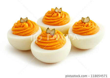 Closeup of deviled eggs garnished with herbs and paprika on white background. Concept of appetizers and holiday food 118054571