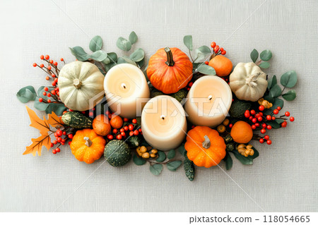 Autumn flat lay featuring pumpkins, candles, and leaves background. Concept of fall, harvest, and Halloween decoration 118054665