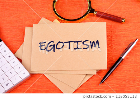 Concept image. the word EGOTISM on postal envelopes on an orange background, top view Concept image. the word EGOTISM on postal envelopes on an orange background, top view 118055118