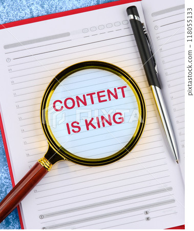 Business and Content is king concept. Copy space. CONTENT IS KING in an open notebook through a magnifying glass, top view 118055133