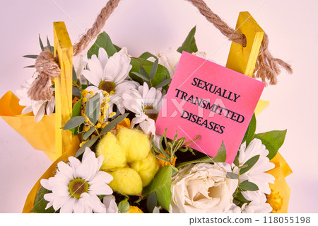 SEXUALLY TRANSMITTED DISEASES written on a sticker in a bouquet of flowers 118055198