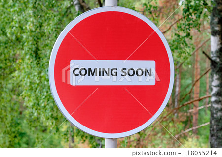 Conceptual coming soon symbol. Copy space. COMING SOON words written traffic is prohibited on the sign against the background of the forest 118055214
