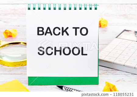 For backgrounds and presentations. The words Back to School on a blank sheet of a desktop notebook 118055231