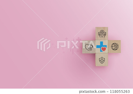 Hand arranging wood block with health care medical icon on pink background. health insurance, love, international cardiology day, check up, heart attack and cardiology. 118055263
