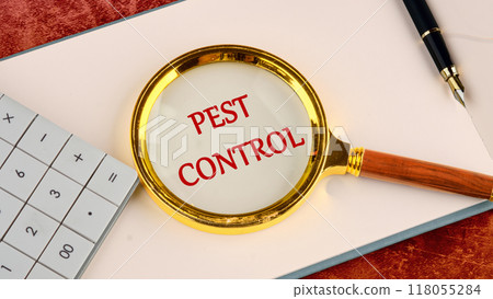 Pest control phrase written through a magnifying glass in red letters in a notebook on a blank sheet 118055284