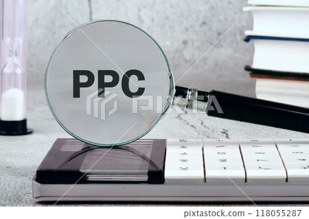 PPC. Pay Per Click concept Businessman working concept, social network, SEO. PPC written on the background through a magnifying gla PPC. Pay Per Click concept Businessman working concept, social network, SEO. PPC written on the background through a magnifying gla 118055287