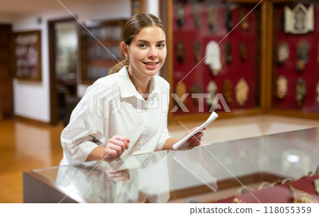 Young woman with information booklet visiting museum 118055359