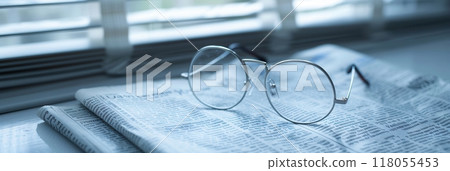 A pair of eyeglasses lies on an open newspaper, with a window in the background. Generative AI A pair of eyeglasses lies on an open newspaper, with a window in the background. Generative AI 118055453