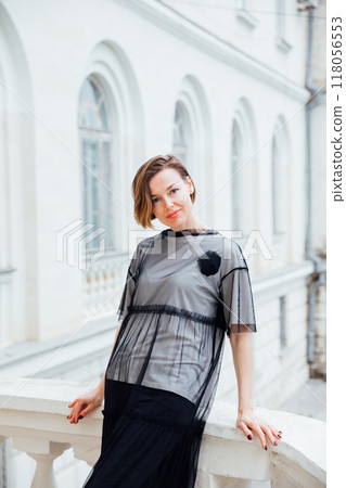 Beautiful woman of 40 years old walking through the streets of the city 118056553