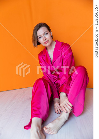 Beautiful woman in pink silk fashion pajamas 118056557