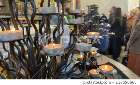 Burning candles in a Catholic church during the Divine Service. Burning candles in a Catholic church during the Divine Service. 118056665