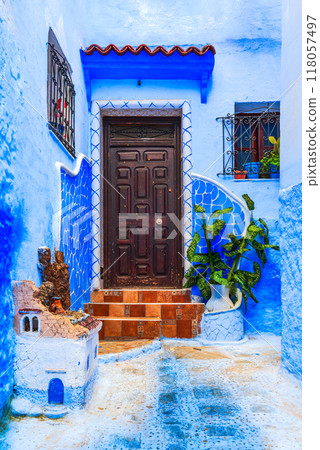 Chefchaouen, Morocco. Blue medina, ancient city, staircase and wall decorated with colourful flowerpots. Chefchaouen, Morocco. Blue medina, ancient city, staircase and wall decorated with colourful flowerpots. 118057497