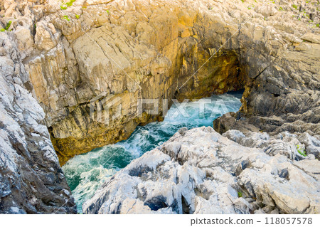 Famous natural sea cave at Llanes Asturias, Spain. landscape of the waves splashing at a natural 118057578