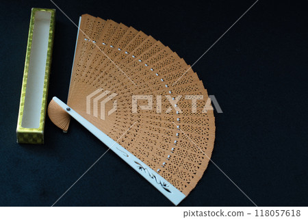 Japanese clothing accessory, folding fan, black background 118057618