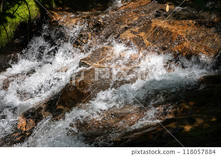 River water rushing over rocks 118057884