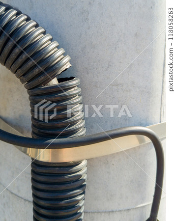 Poorly Secured Electrical Installation with Damaged Conduit Poorly Secured Electrical Installation with Damaged Conduit 118058263