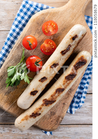 Grilled bratwurst sausages with tomatoes on wooden tabke Grilled bratwurst sausages with tomatoes on wooden tabke 118058679