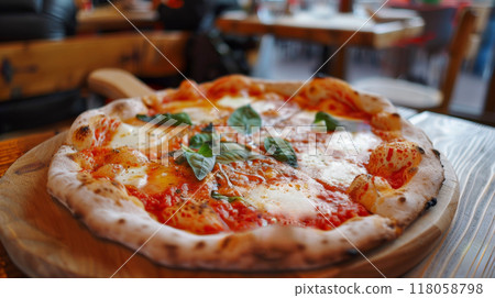 pizza on wooden table in pizzeria restaurant background 118058798