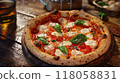 pizza on wooden table with ingredients top view  118058831