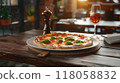 pizza on wooden table in pizzeria restaurant background 118058832