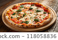 pizza on wooden table with ingredients top view  118058836