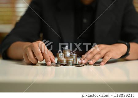 A man is playing a game with coins on a table 118059215