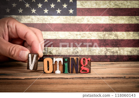 VOTING. Colorful letters of the alphabet on a wooden texture table 118060143