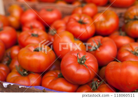 Fresh tomatoes on branch in wicker baskets on counter 118060511