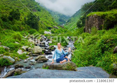 Woman doing Ardha matsyendrasana asana asana outdoors 118061307
