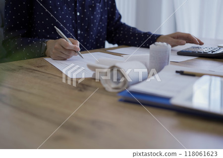 Accountants or auditors reviewing financial documents while usin 118061623