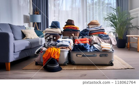 Clothes overflowing from a travel suitcase Clothes overflowing from a travel suitcase 118062764