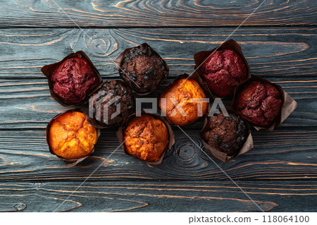 Mix of muffins ( cupcake ) chocolate , vanilla , berries . Top view 118064100