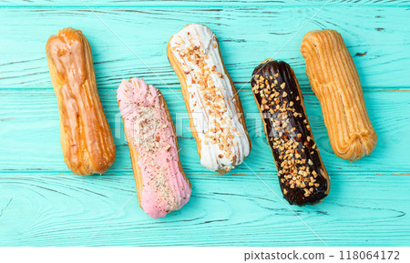 Assorted eclairs on a pastel top view Traditional French dessert Assorted eclairs on a pastel top view Traditional French dessert 118064172