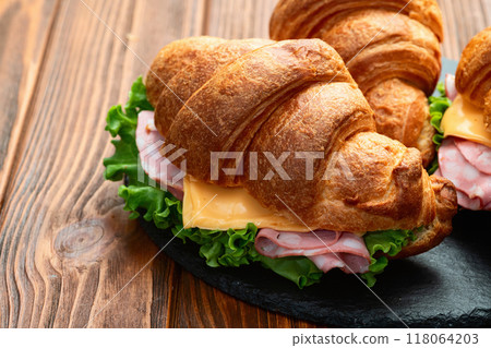 Croissant sandwich with salad ham and cheese . Top view Croissant sandwich with salad ham and cheese . Top view 118064203