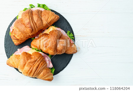 Croissant sandwich with salad ham and cheese . Top view Croissant sandwich with salad ham and cheese . Top view 118064204