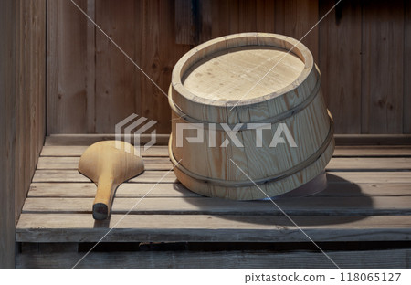 The wooden bucket and ladle sitting on wooden benches in the wooden sauna room. 118065127