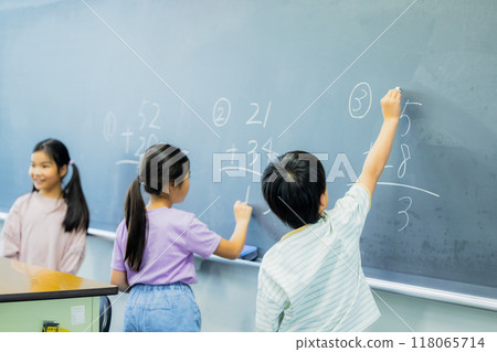 Elementary school students taking lessons in a classroom Elementary school students taking lessons in a classroom 118065714